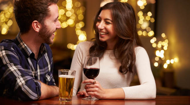 couple enjoying evening drinks in bar